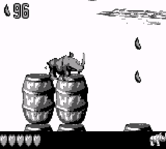 Rambi the Rhino stands atop a stack of barrels in one of the pirate themed stages.