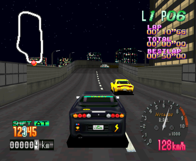 The car drives on a populated street at night.