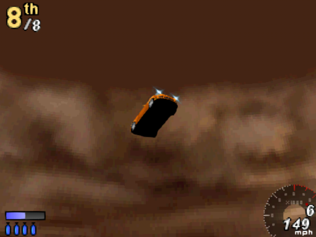 The trick camera shows a view from below as the player's car goes off a jump.