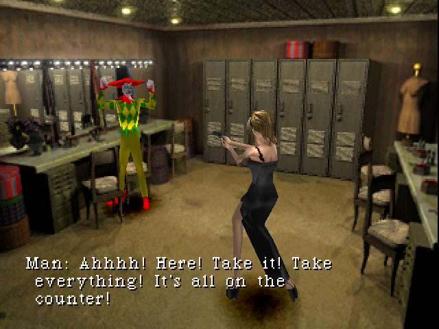 Aya holds a clown in a dressing room at gunpoint.