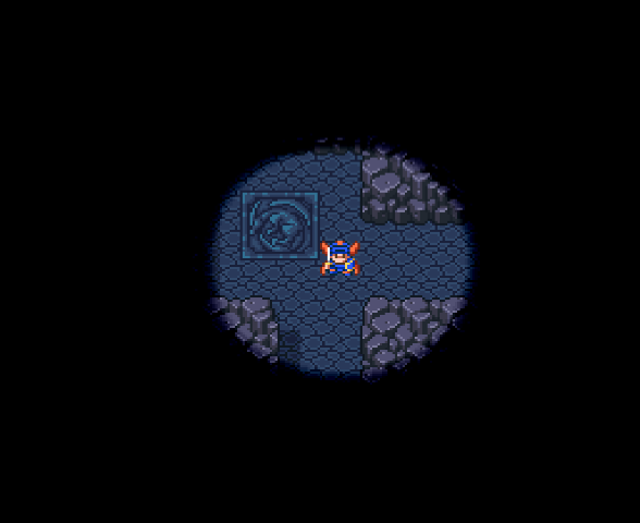 Exploring a dark cave lit by a torch in Dragon Quest.