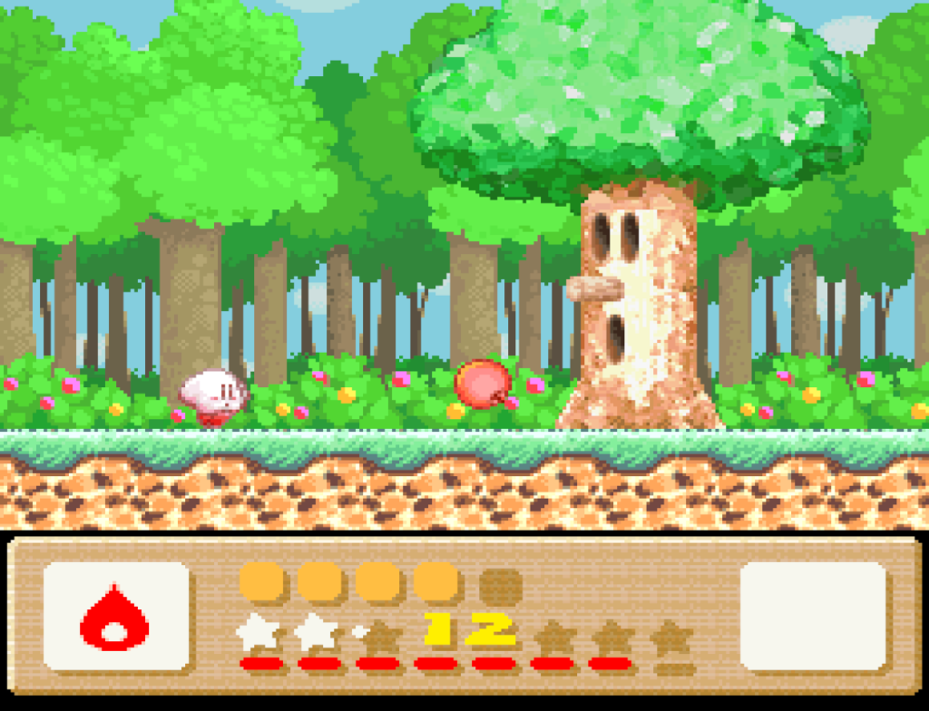 Kirby battles an evil tree in one of the early boss encounters.