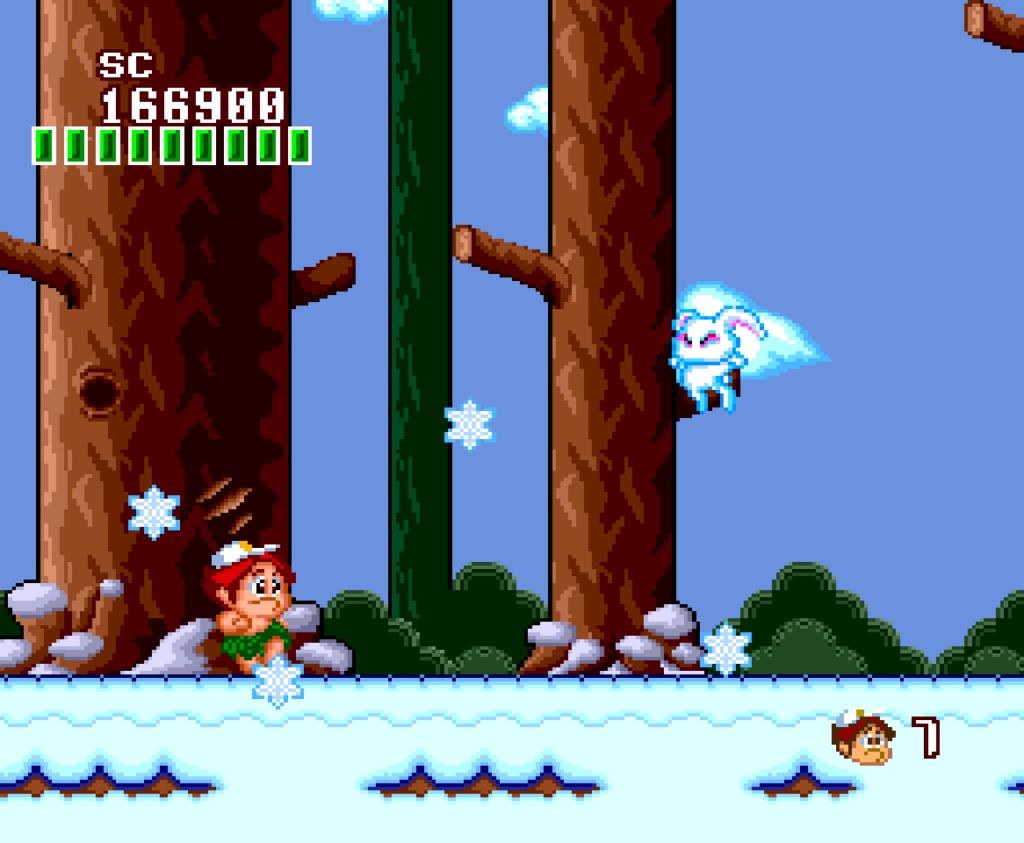 Master Higgins fights against a rabbit in a snow based forest level.