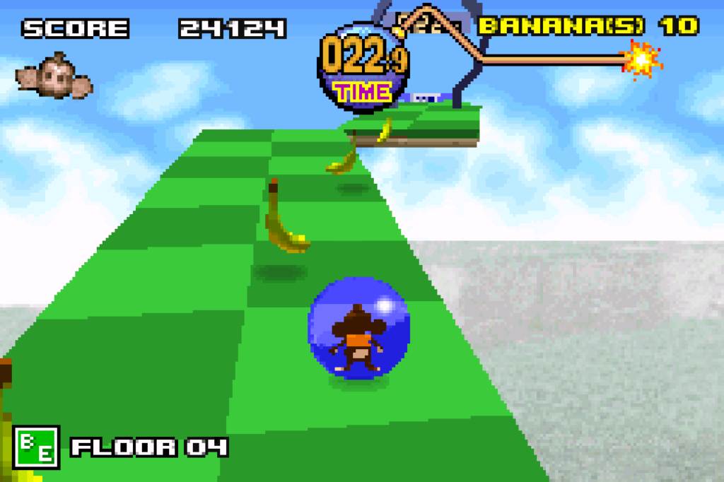 The ball rolls forward toward a banana on a moving platform in an outdoor scene.