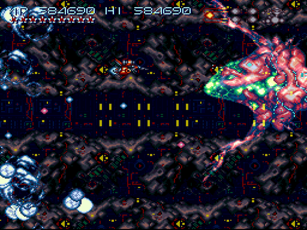 A boss battle in Axelay against an alien creature on the wall of a cavern.