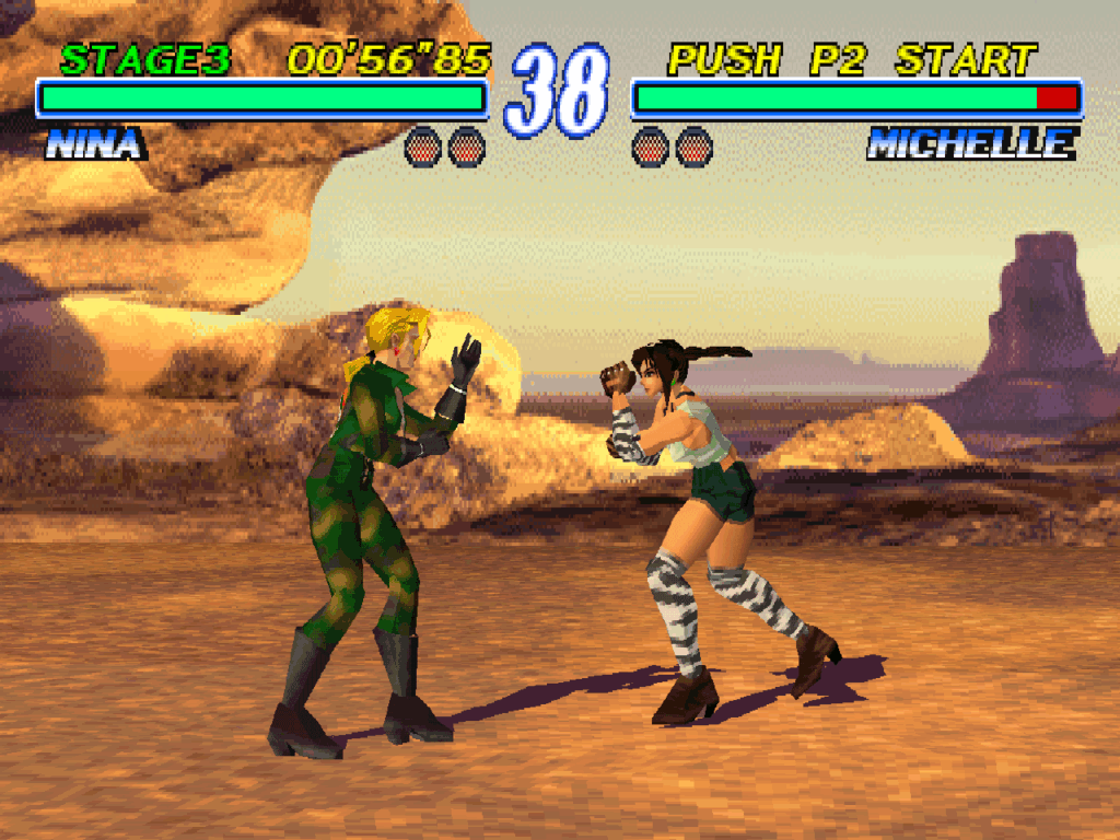 Nina and Michelle fight in a desert stage with rock formations in the background.