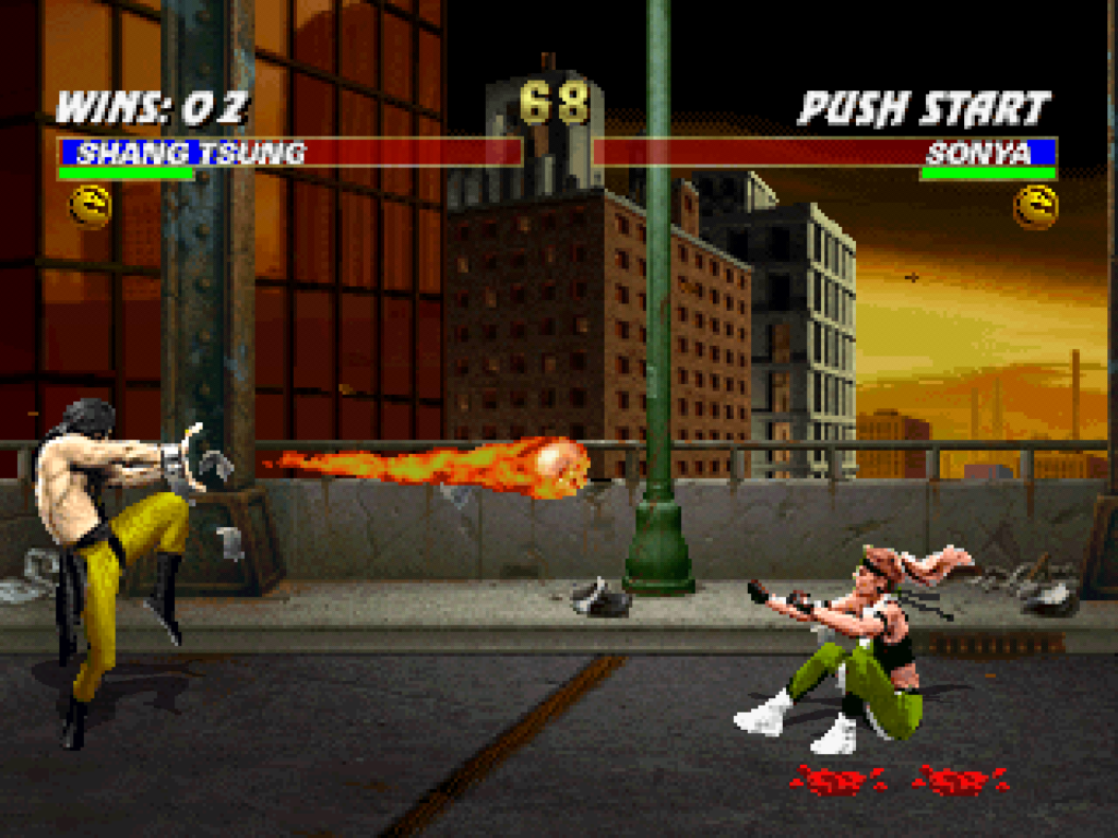 Shang Tsung shoots fireballs at Sonya Blade in a battlefield with a cityscape.